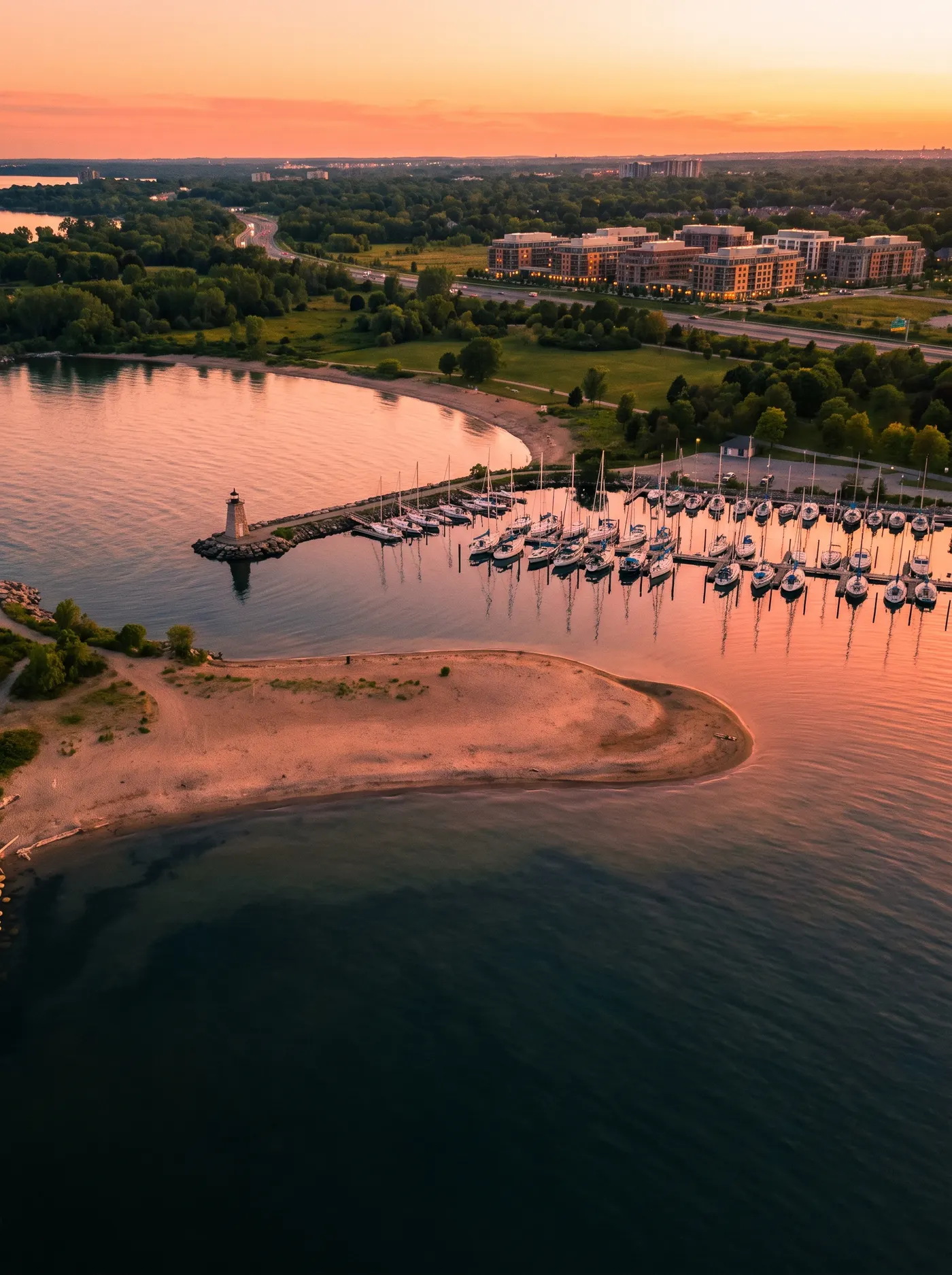 Marina and lighthouse on the lake shore at golden hour