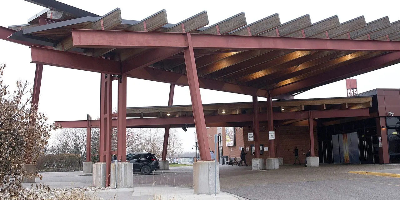 Casino Ajax: the timber-and-steel entrance canopy and the drop-off loop on an overcast day